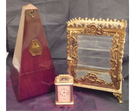 A French brass cased table top display case in the Rococo manner with glazed side panels, a mahogany metronome bearing label 