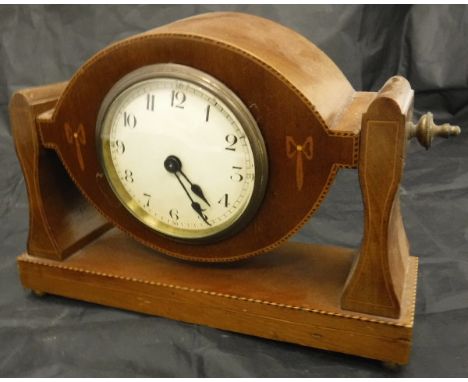 An Edwardian mahogany and inlaid adjustable mantle clock with of propeller centre form with a French movement 