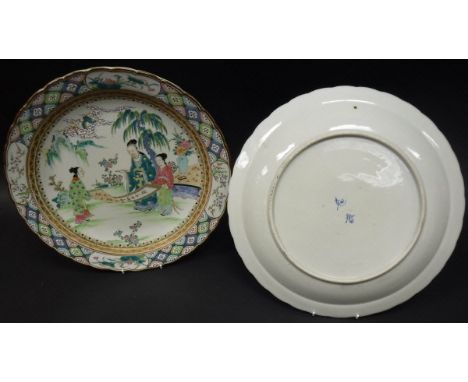 A pair of Chinese ploychrome decorated chargers, the centre fields decorated with figures and scroll in garden setting, raise