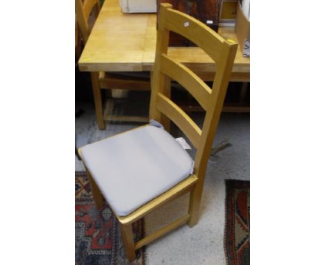 A modern beech rectangular kitchen table and set of seven panel seat ladder back chairs