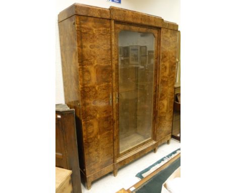 An early 20th Century burr yew bookcase cabinet in the Biedermeier style, the central glazed door enclosing adjustable shelvi