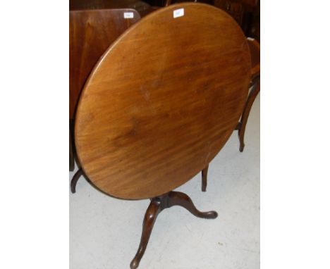 A 19th Century mahogany tea table, the circular snap top on a turned pedestal to cabriole tripod base