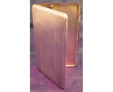 A George VI silver cigarette case of rectangular form with engine turned decoration and gilt washed interior (by E Scott & Co