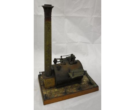 A circa 1900 Gebrüder Bing stationary steam engine with large cylinder flanked by two pairs of steps and brick chimney on a t