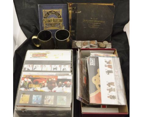 A box containing a collection of various first day covers, two albums of various British and World stamps, one volume second 