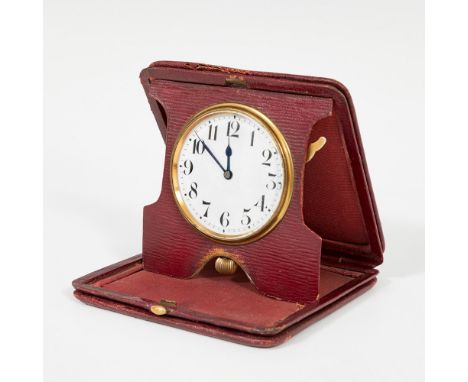 Travel alarm clock; late 19th - early 20th century.Red dyed leather case.Measurements: 10 x 10,5 cm.Travel alarm clock with o