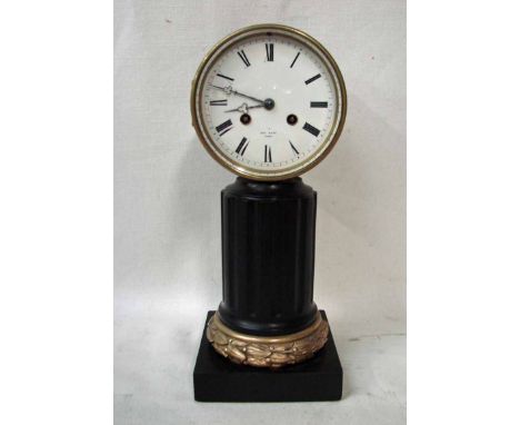 An early 20th century French Drum Clock in brass case, white enamel dial with black Roman numerals, strikes the half hours on