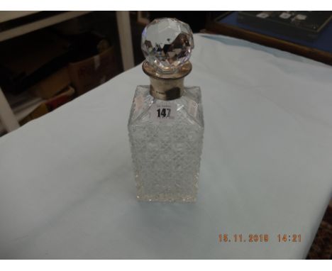 A decanter with hallmarked silver collar