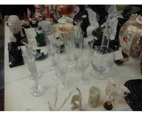 A Faberge crystal decanter and six glasses plus a pair of candlesticks, one glass a/f