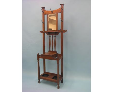 A late Victorian solid walnut hall stand, features include brass coat hooks, bevelled mirror plate, glove box and stick-stand