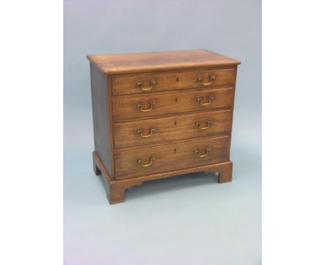 A small Chippendale-period mahogany chest, four long drawers, each oak-lined with original brass swan-neck handles, bracket f