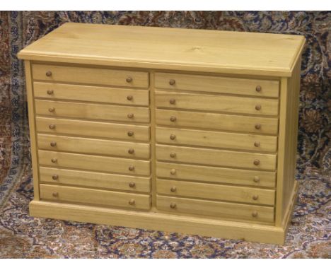 A light beech specimen chest, two banks of eight shallow drawers, turned wood knob handles, 24in. 