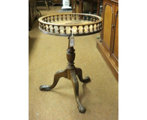 A mahogany wine table, circular top with turned spindle gallery, tripod base with carved detail, top 1ft. 6in. 