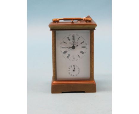 A modern engraved brass repeating carriage clock, enamelled dial bearing a signature, Dent, bell-striking movement, with key,