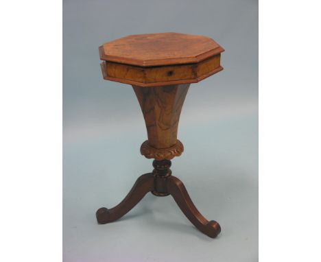 A Victorian burr walnut work table, octagonal-shape with enclosed fittings and accessories, on tapering stem and tripod base,