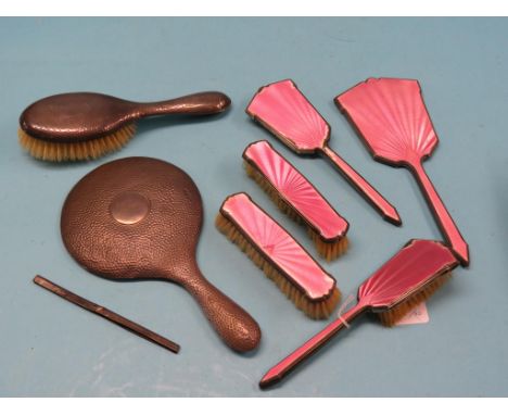 An hammered silver hand-mirror and hairbrush, enamelled five-piece silver dressing table set, enamel a.f. and a silver comb m