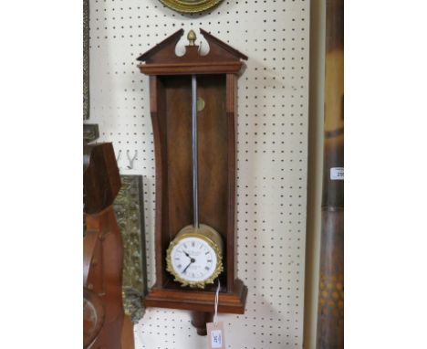 A Georgian-style mahogany gravity wall clock, rise and fall mechanism within recess, architectural pediment, 27in. 