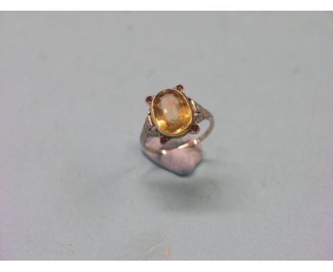 An 18ct. white gold and platinum dress ring, set faceted oval citrine and four small rubies, shoulders mounted with diamond c