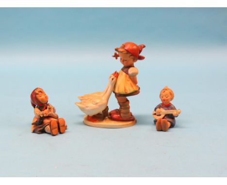 A large Goebel figure, girl with two geese, 8in. and two smaller similar figures, designed by Hummel 