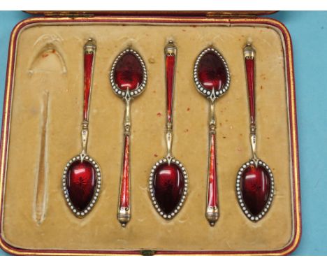 A part-set of five silver-gilt coffee spoons, with translucent ruby enamel detail, London import marks, 1900, within original