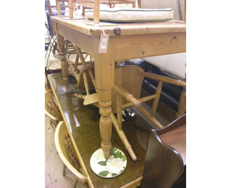 A modern, waxed pine kitchen table, on turned legs, 4ft. x 2ft. 6in. and a set of four light beech dining chairs