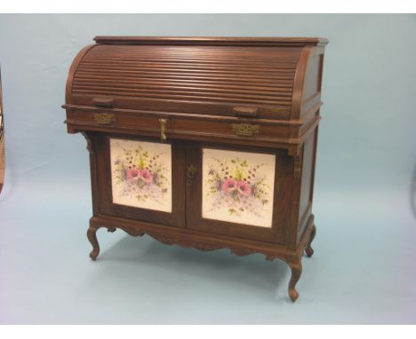 An eastern solid rosewood roll-top desk, drawers and hinged recesses enclosed by tambour shutter, cupboard base with inset ce