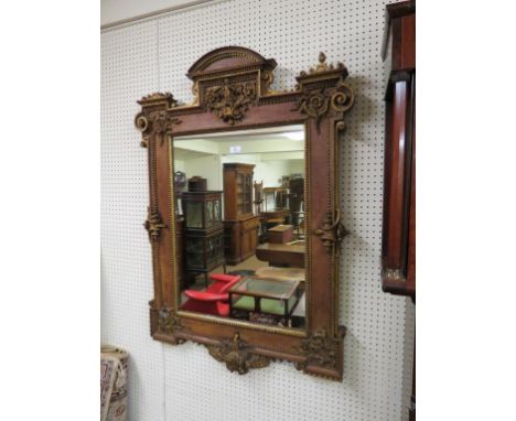 A George II walnut and parcel-gilt mirror, architectural form with domed pediment and corner scrolls, carved giltwood details