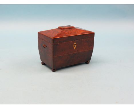 An early 19th century burr-yew tea caddy, sarcophagus-shape with two covered canisters, 8in.