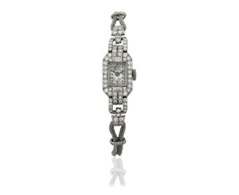 A lady's platinum and diamond set manual wind cocktail watchDate: Circa 1950Movement: Jewelled manual windDial: Silvered, bla