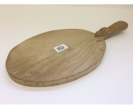 An early Robert Thompson Mouseman circular oak breadboard with single handle with mouse decoration to handle.