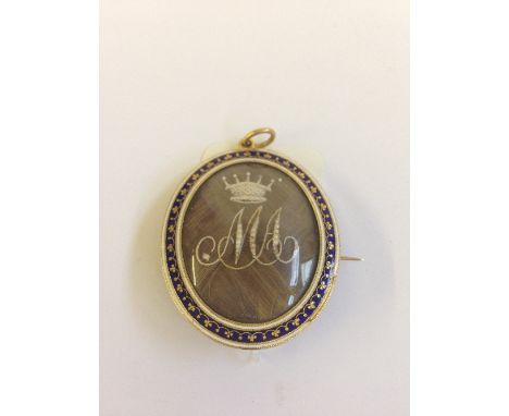 A Victorian gilt and enamel double sided hair locket, inscribed M A with coronet above (minor faults to enamel).