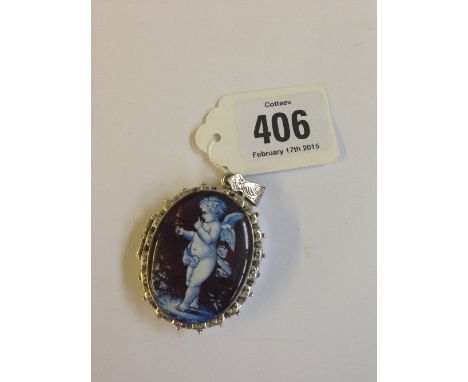 A silver and enamel locket decorated with a cherub.