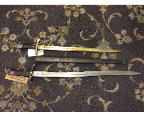 An 1885 Portuguese Guedes bayonet in metal scabbard together with another (no scabbard).