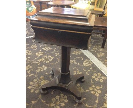 A 19th century rosewood teapoy with four caddy fitted interior.