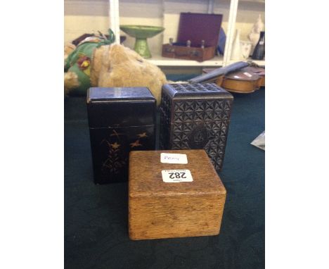 Three wooden playing card boxes.
