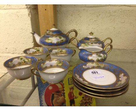 The residue of a Noritake Afternoon teaset with painted panels depicting Mount Fuji and lake scenes on blue and gilt ground (