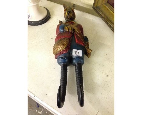 A painted coat hook, modelled as a Rabbit dressed in hunting gear.