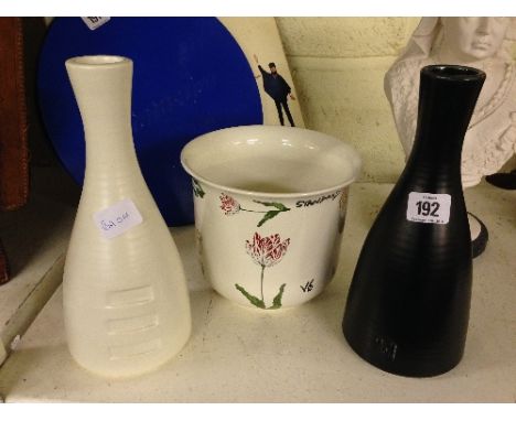 A Poole Pottery black glazed bottle shaped vase together with a similar white glazed vase, designed by Kelly Hoppen and a Tif