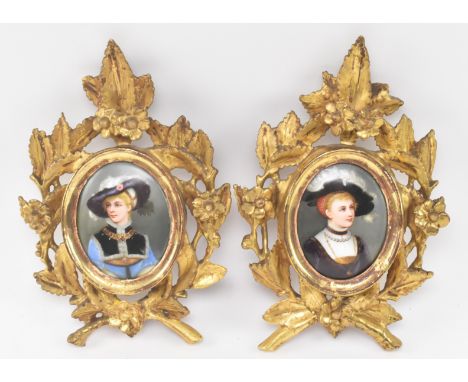 A pair of Victorian 19th century hand painted miniature oval portrait paintings on porcelain in gilt ornate frames. The lot t