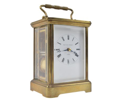 Matthew Norman - An early 20th century Swiss made brass carriage clock. The clock of typical form, bevelled glass inserts int