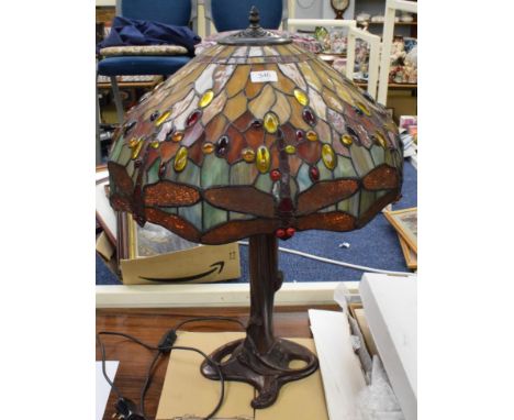 A large Tiffany style table lamp with shade decorated with dragon flies