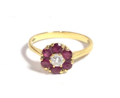 An 18 carat gold ruby and diamond cluster ring, finger size L.  Gross weight 3.05 grams. 