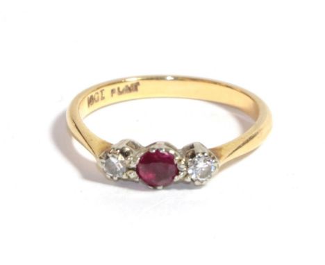 A synthetic ruby and diamond three stone ring, stamped '18CT' and 'PLAT', finger size M1/2.  Gross weight 2.56 grams. 