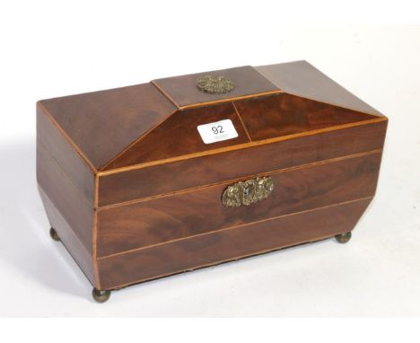 An early 19th century Sarcophagus shaped satinwood banded mahogany tea caddy, the interior with twin compartments and period 