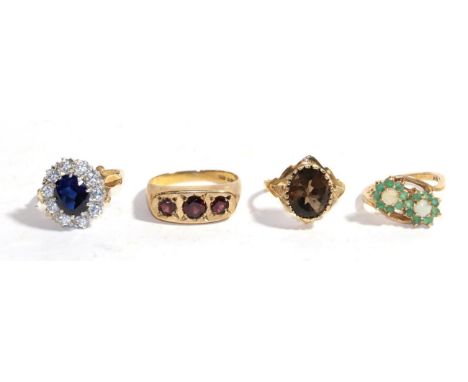 Four 9 carat gold gem set rings including a garnet example, an opal and emerald example etc, various finger sizes .  Gross we