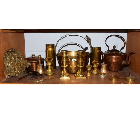A quantity of late 19th century copper and brass, including dump weights, jam pans, candlesticks, an Edwardian mantle clock, 