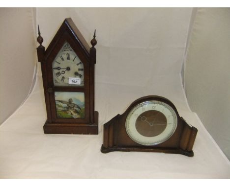 An early 20th Century American walnut cased mantel clock, the glazed door bearing picture of a boy and eagle, together with a