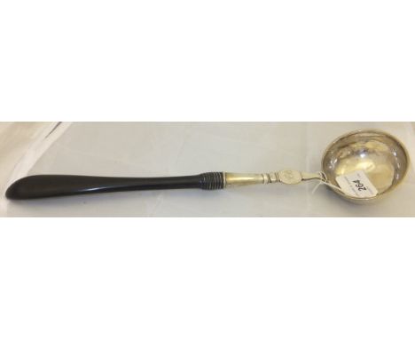 A 19th Century white metal and ebony handled soup ladle, initialled "FB" to front and stamped "Hartman" to back
