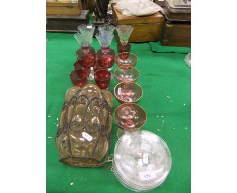 A collection of glassware to include a set of seven small cut glass plates decorated with hops, a glass lantern with metal mo