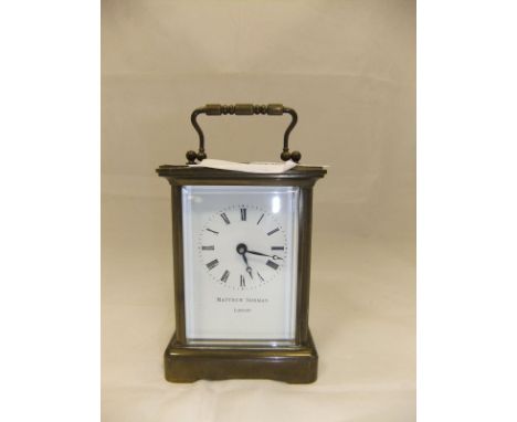 A four glass carriage brass carriage clock, the white enamelled dial inscribed "Matthew Norman London" and bearing Roman nume
